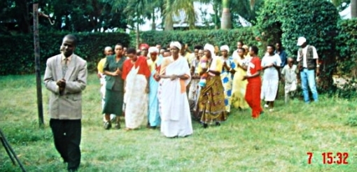 Evonne, in the middle front, is led to the tent by women relatives, with her uncle (in front)