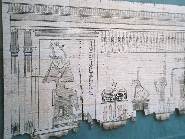 Papyrus on which segments of the Book of the Dead are written, together with drawings - here, Osiris overseeing the crucial act of weighing the heart of the deceased.  Source - Wikipedia